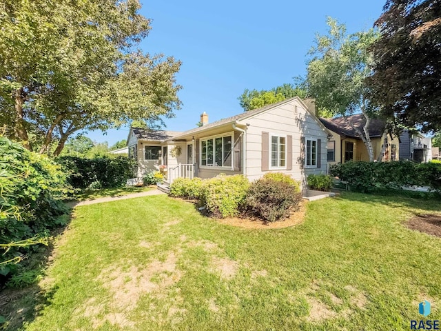 612 E 26th St, Sioux Falls, SD 57105 - view of front facade featuring a front lawn and a chimney