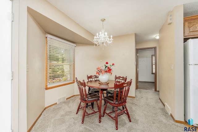 612 E 26th St, Sioux Falls, SD 57105 - dining area with light carpet and a chandelier