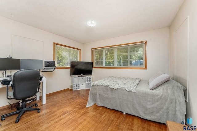 612 E 26th St, Sioux Falls, SD 57105 - bedroom with wood finished floors and a desk