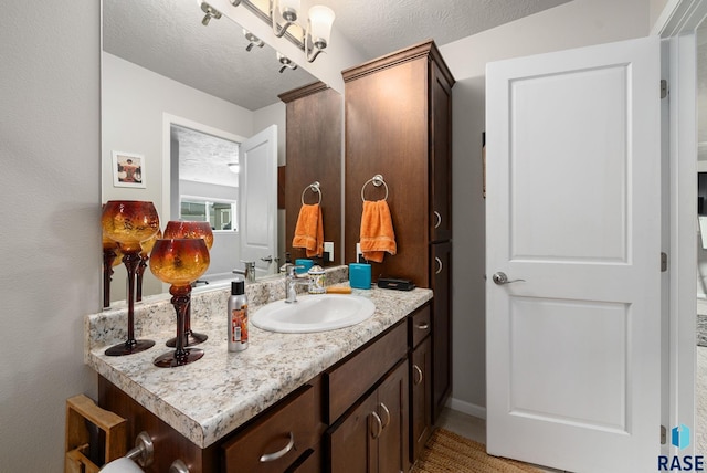 601 W Highpointe St, Tea, SD 57064 - bathroom with vanity and a textured ceiling