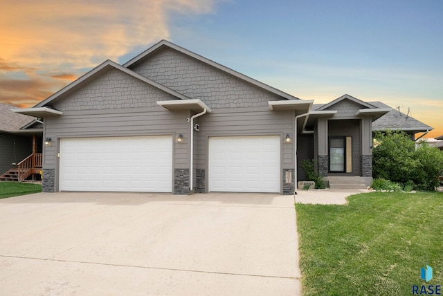 601 W Highpointe St, Tea, SD 57064 - craftsman inspired home featuring a garage, driveway, stone siding, and a yard