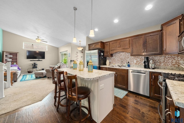 601 W Highpointe St, Tea, SD 57064 - kitchen featuring appliances with stainless steel finishes, open floor plan, light countertops, lofted ceiling, and backsplash