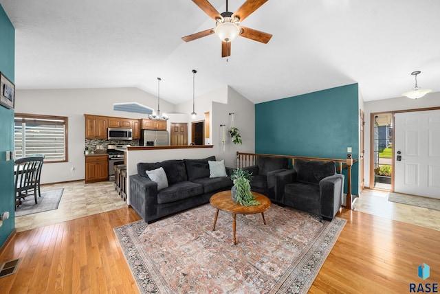 1413 Holbrook Ave, Sioux Falls, SD 57107 - living room featuring a ceiling fan, lofted ceiling, light wood finished floors, and plenty of natural light