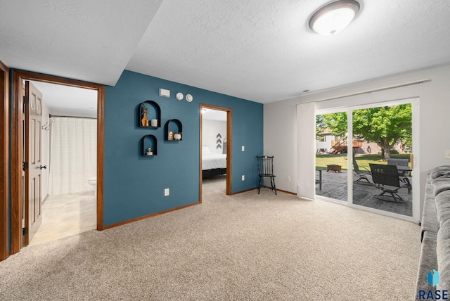 1413 Holbrook Ave, Sioux Falls, SD 57107 - unfurnished bedroom featuring access to exterior, a textured ceiling, light carpet, and ensuite bathroom