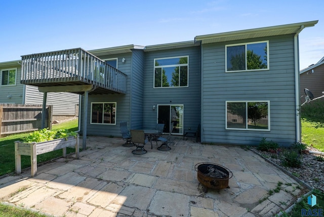 1413 Holbrook Ave, Sioux Falls, SD 57107 - back of property with an outdoor fire pit, a patio, and a wooden deck