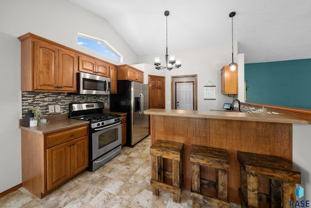 1413 Holbrook Ave, Sioux Falls, SD 57107 - kitchen with appliances with stainless steel finishes, tasteful backsplash, lofted ceiling, a chandelier, and brown cabinets