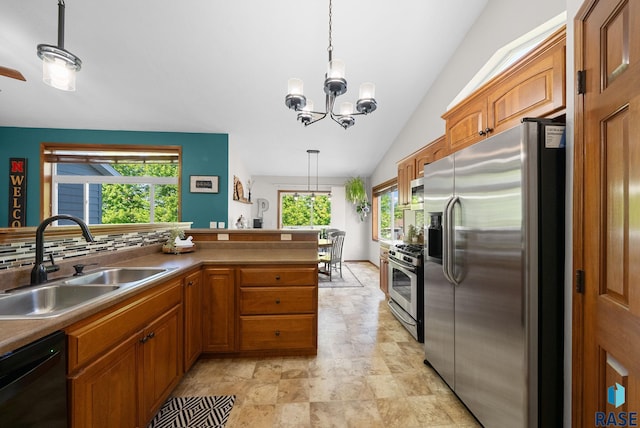 1413 Holbrook Ave, Sioux Falls, SD 57107 - kitchen with stainless steel appliances, brown cabinets, hanging light fixtures, stone finish flooring, and vaulted ceiling