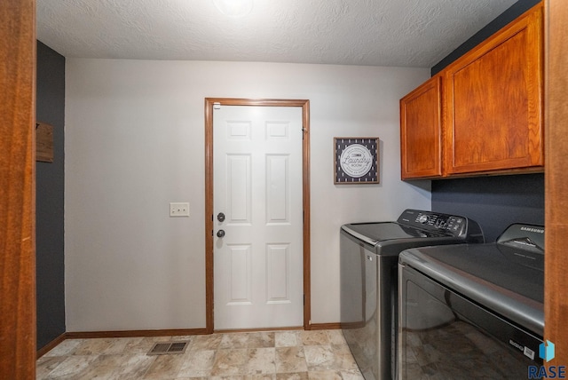 1413 Holbrook Ave, Sioux Falls, SD 57107 - laundry room featuring cabinet space, washer and clothes dryer, and a textured ceiling