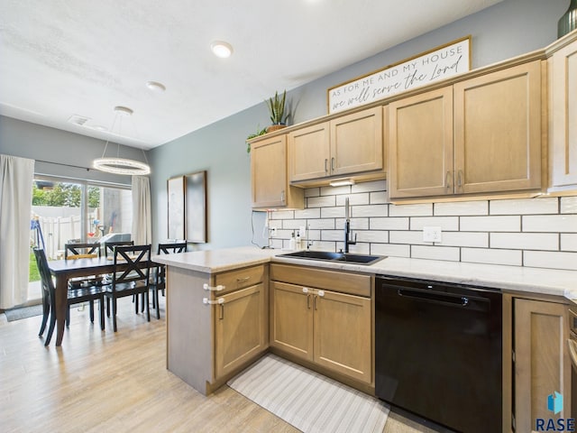 2560 E Meadowside Pl, Sioux Falls, SD 57108 - kitchen with dishwasher, light wood finished floors, backsplash, a peninsula, and hanging light fixtures