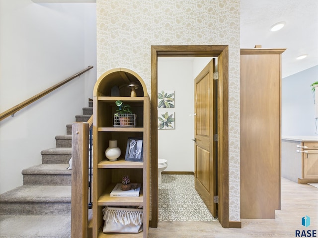 2560 E Meadowside Pl, Sioux Falls, SD 57108 - stairway featuring wood finished floors and wallpapered walls