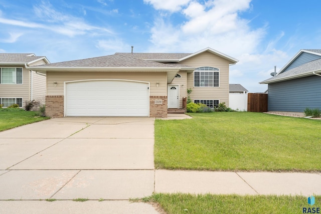 7409 W 51st St, Sioux Falls, SD 57106 - view of front of property with brick siding, driveway, and an attached garage