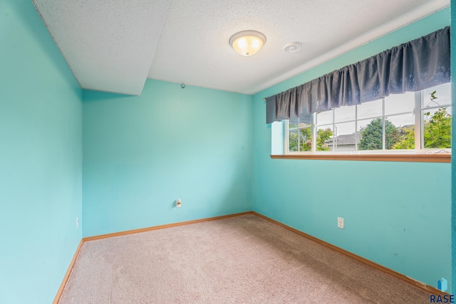 7409 W 51st St, Sioux Falls, SD 57106 - carpeted spare room featuring a textured ceiling and baseboards