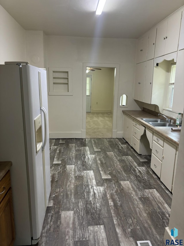 3605 E 12th St, Sioux Falls, SD 57103 - kitchen with white fridge with ice dispenser, dark wood-style flooring, white cabinets, and ceiling fan