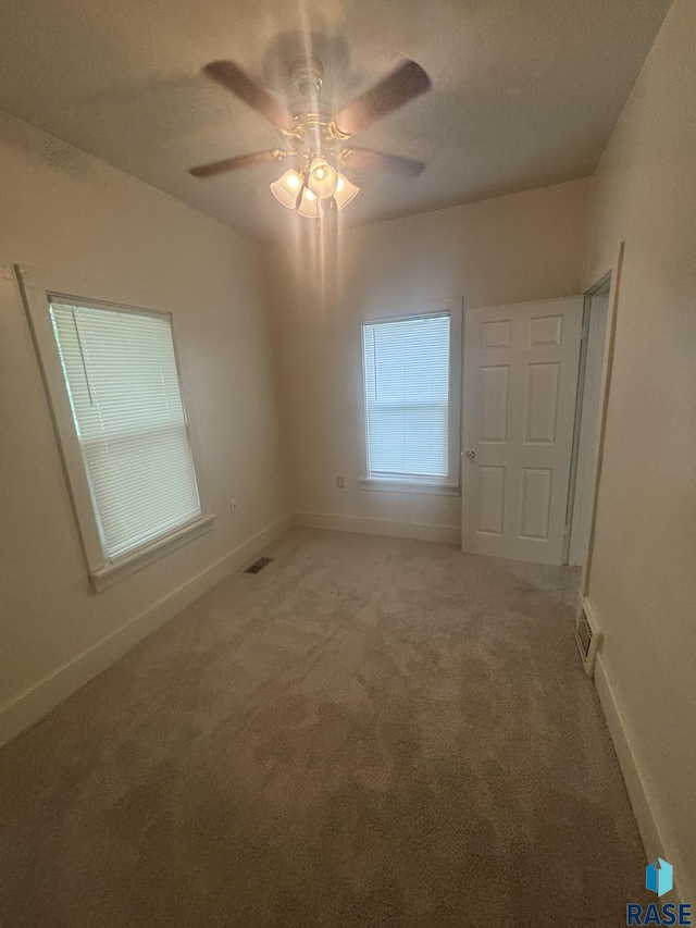 3605 E 12th St, Sioux Falls, SD 57103 - spare room featuring light carpet and ceiling fan