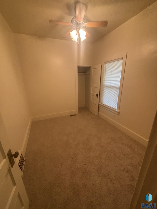3605 E 12th St, Sioux Falls, SD 57103 - unfurnished bedroom with light carpet, a ceiling fan, and a closet