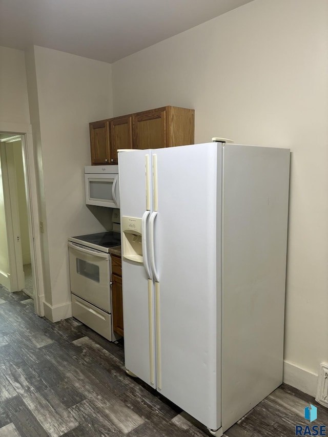 3605 E 12th St, Sioux Falls, SD 57103 - kitchen featuring white appliances, dark wood-type flooring, and brown cabinetry