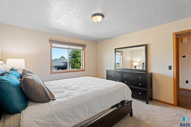 9232 W Norma Trl Unit 2, Sioux Falls, SD 57106 - bedroom featuring light colored carpet and a textured ceiling