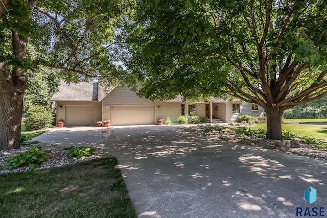 6500 E Split Rock Rd, Sioux Falls, SD 57110 - view of property hidden behind natural elements featuring a garage and concrete driveway