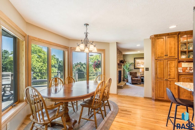 6500 E Split Rock Rd, Sioux Falls, SD 57110 - dining area featuring a chandelier, light wood-style flooring, recessed lighting, and a fireplace