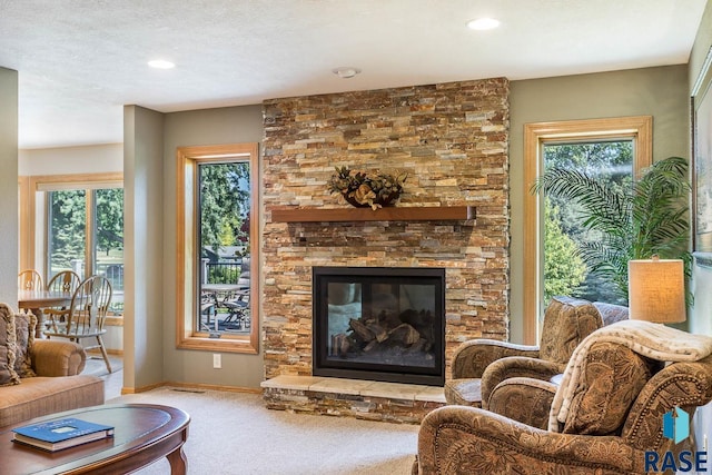 6500 E Split Rock Rd, Sioux Falls, SD 57110 - living area featuring carpet flooring, a stone fireplace, plenty of natural light, and recessed lighting