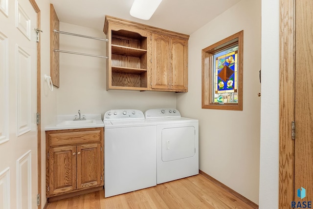 303 E 11th St, Dell Rapids, SD 57022 - laundry area featuring cabinet space, washer and dryer, and light wood finished floors