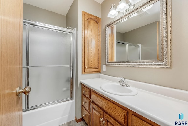 303 E 11th St, Dell Rapids, SD 57022 - bathroom featuring vanity and bath / shower combo with glass door