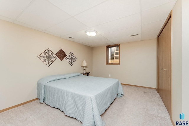 303 E 11th St, Dell Rapids, SD 57022 - carpeted bedroom with a drop ceiling and baseboards