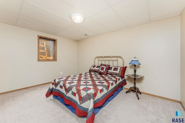 303 E 11th St, Dell Rapids, SD 57022 - carpeted bedroom featuring a drop ceiling and baseboards