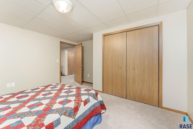 303 E 11th St, Dell Rapids, SD 57022 - bedroom featuring a paneled ceiling, light carpet, and a closet