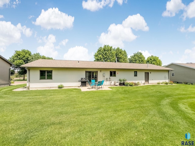 303 E 11th St, Dell Rapids, SD 57022 - rear view of house featuring a patio and a yard