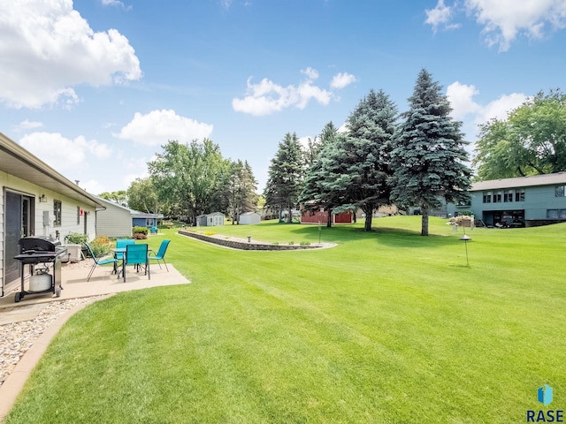 303 E 11th St, Dell Rapids, SD 57022 - view of green lawn featuring a patio area