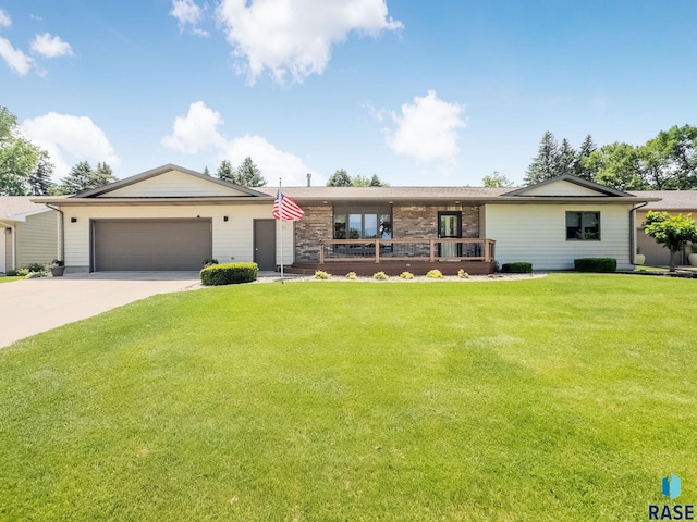 303 E 11th St, Dell Rapids, SD 57022 - view of front of property featuring a garage, driveway, and a front lawn