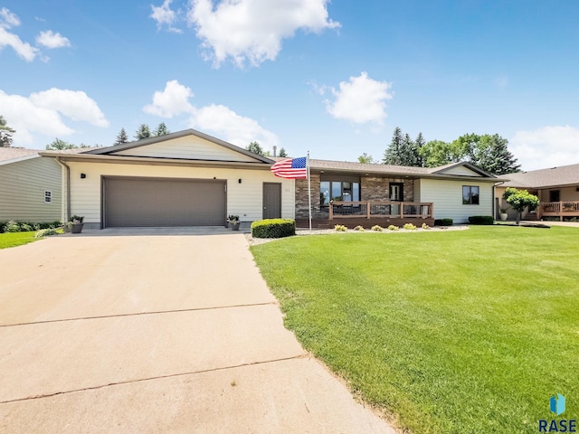 303 E 11th St, Dell Rapids, SD 57022 - ranch-style house featuring driveway, an attached garage, and a front lawn