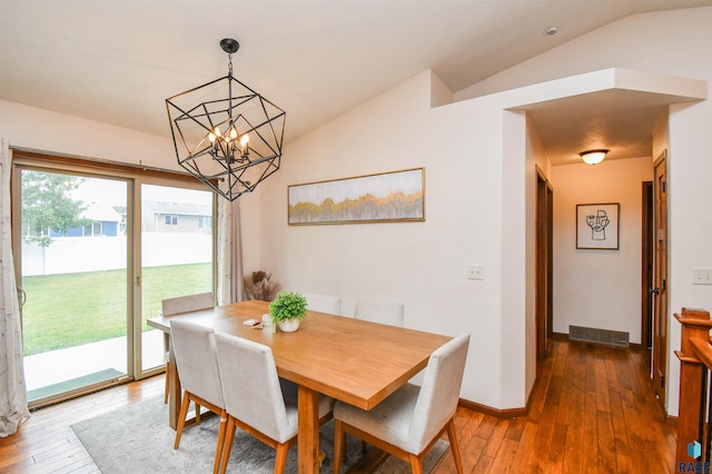 3208 S Triple Play Ave, Sioux Falls, SD 57110 - dining area featuring vaulted ceiling, hardwood / wood-style floors, and a chandelier