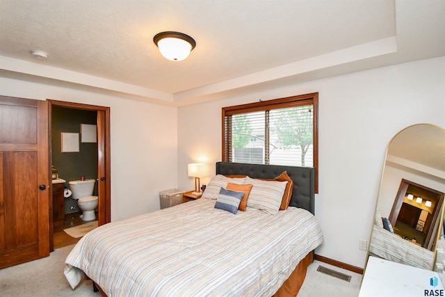 3208 S Triple Play Ave, Sioux Falls, SD 57110 - bedroom with light carpet, a raised ceiling, and ensuite bathroom