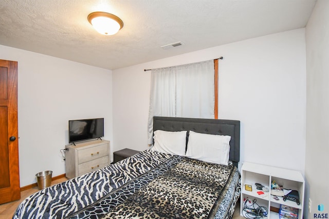 3208 S Triple Play Ave, Sioux Falls, SD 57110 - bedroom featuring a textured ceiling and wood finished floors