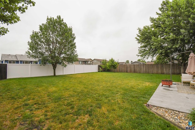 3208 S Triple Play Ave, Sioux Falls, SD 57110 - fenced backyard featuring a patio area and an outdoor fire pit