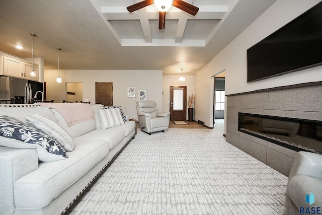 7905 S Brande Park Cir, Sioux Falls, SD 57108 - living room with coffered ceiling, a ceiling fan, beamed ceiling, and a tiled fireplace