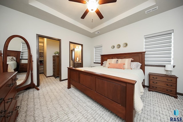 7905 S Brande Park Cir, Sioux Falls, SD 57108 - bedroom featuring light carpet, a tray ceiling, ceiling fan, and ensuite bathroom