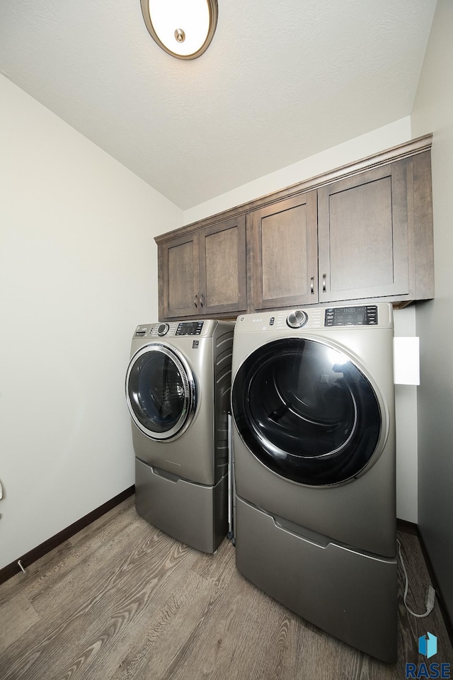 7905 S Brande Park Cir, Sioux Falls, SD 57108 - laundry area featuring cabinet space, independent washer and dryer, and light wood finished floors