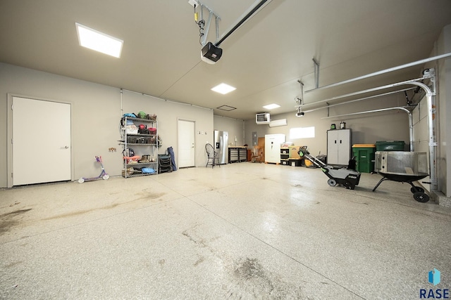 7905 S Brande Park Cir, Sioux Falls, SD 57108 - garage with a garage door opener and stainless steel fridge