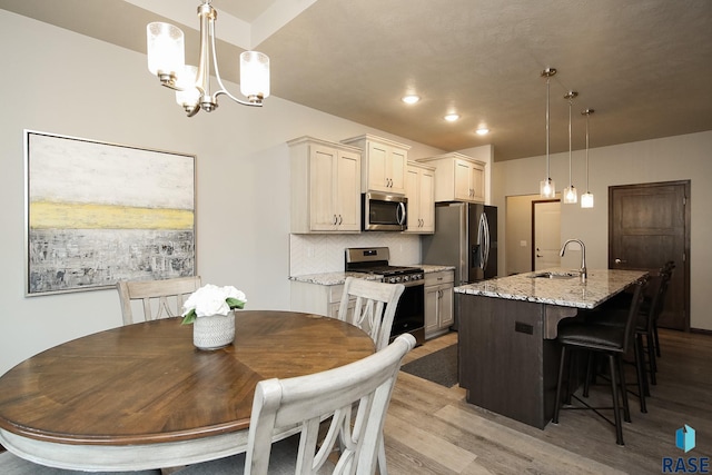 7905 S Brande Park Cir, Sioux Falls, SD 57108 - dining room featuring light wood finished floors, a chandelier, and recessed lighting
