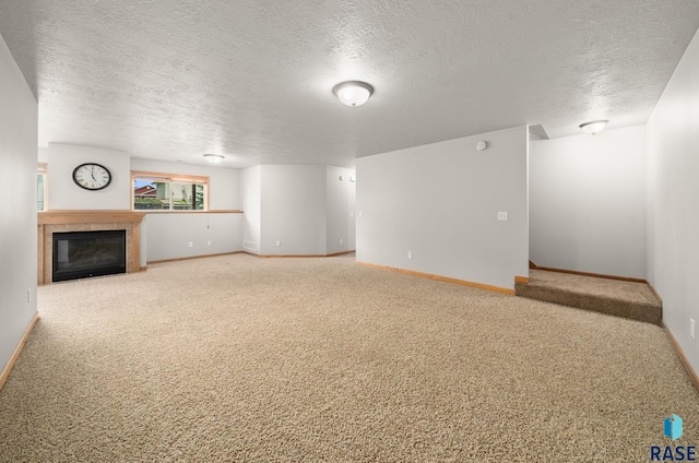 7020 W 53rd St, Sioux Falls, SD 57106 - unfurnished living room featuring carpet, a textured ceiling, and a tiled fireplace