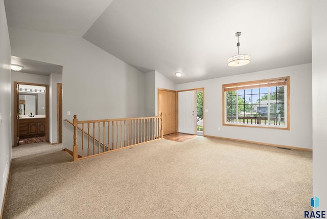 7020 W 53rd St, Sioux Falls, SD 57106 - carpeted spare room featuring lofted ceiling and baseboards