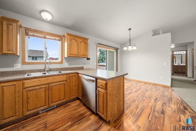 7020 W 53rd St, Sioux Falls, SD 57106 - kitchen with stainless steel dishwasher, vaulted ceiling, a peninsula, a chandelier, and pendant lighting