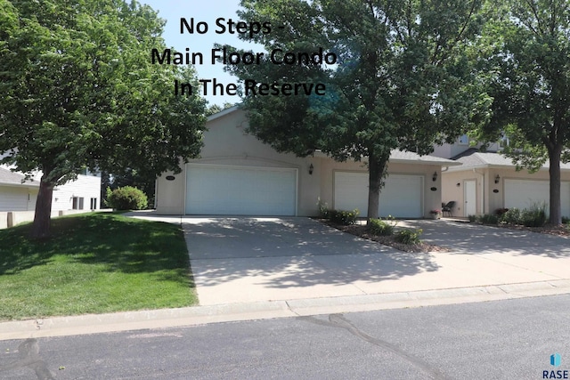 5708 S Shadow Wood Pl, Sioux Falls, SD 57108 - view of property hidden behind natural elements featuring concrete driveway, stucco siding, a front yard, and an attached garage