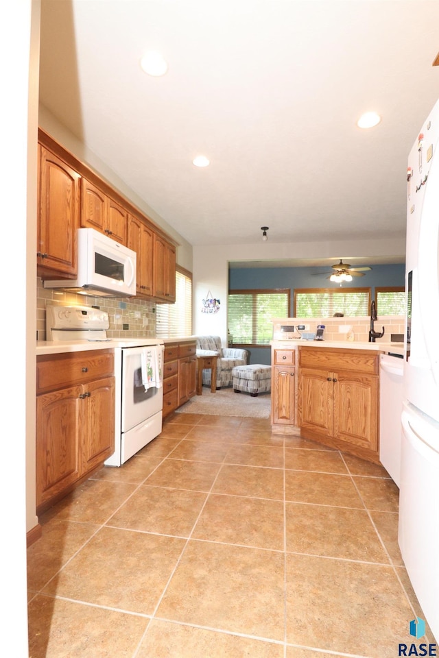5708 S Shadow Wood Pl, Sioux Falls, SD 57108 - kitchen featuring white appliances, tasteful backsplash, light countertops, recessed lighting, and light tile patterned flooring