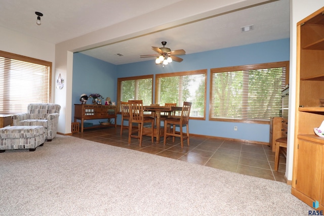5708 S Shadow Wood Pl, Sioux Falls, SD 57108 - carpeted dining room with a ceiling fan and tile patterned floors