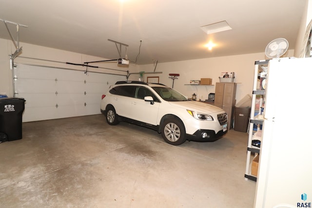 5708 S Shadow Wood Pl, Sioux Falls, SD 57108 - garage featuring freestanding refrigerator and a garage door opener