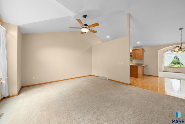 4912 E 42nd St, Sioux Falls, SD 57110 - unfurnished living room with light colored carpet, ceiling fan, vaulted ceiling, and recessed lighting